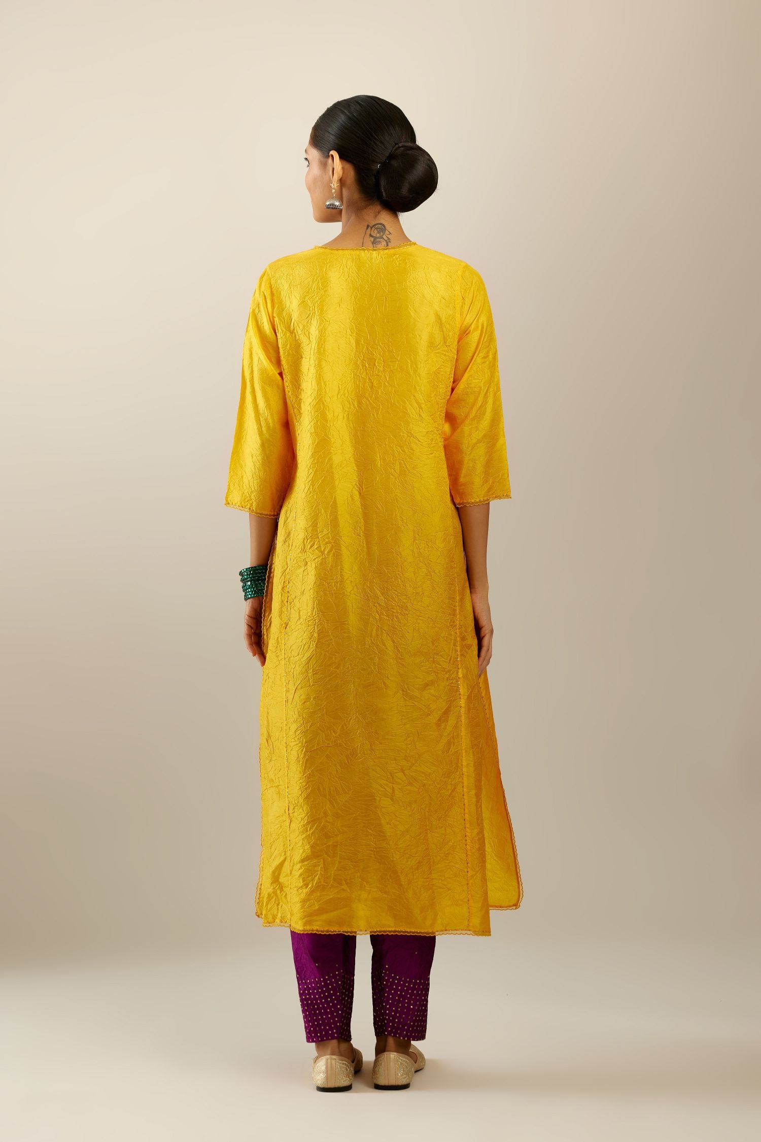 Silk hand crushed kurta set with concealed button placket neckline, highlighted with sequins and scalloped organza at edges.