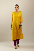 Silk hand crushed kurta set with concealed button placket neckline, highlighted with sequins and scalloped organza at edges.