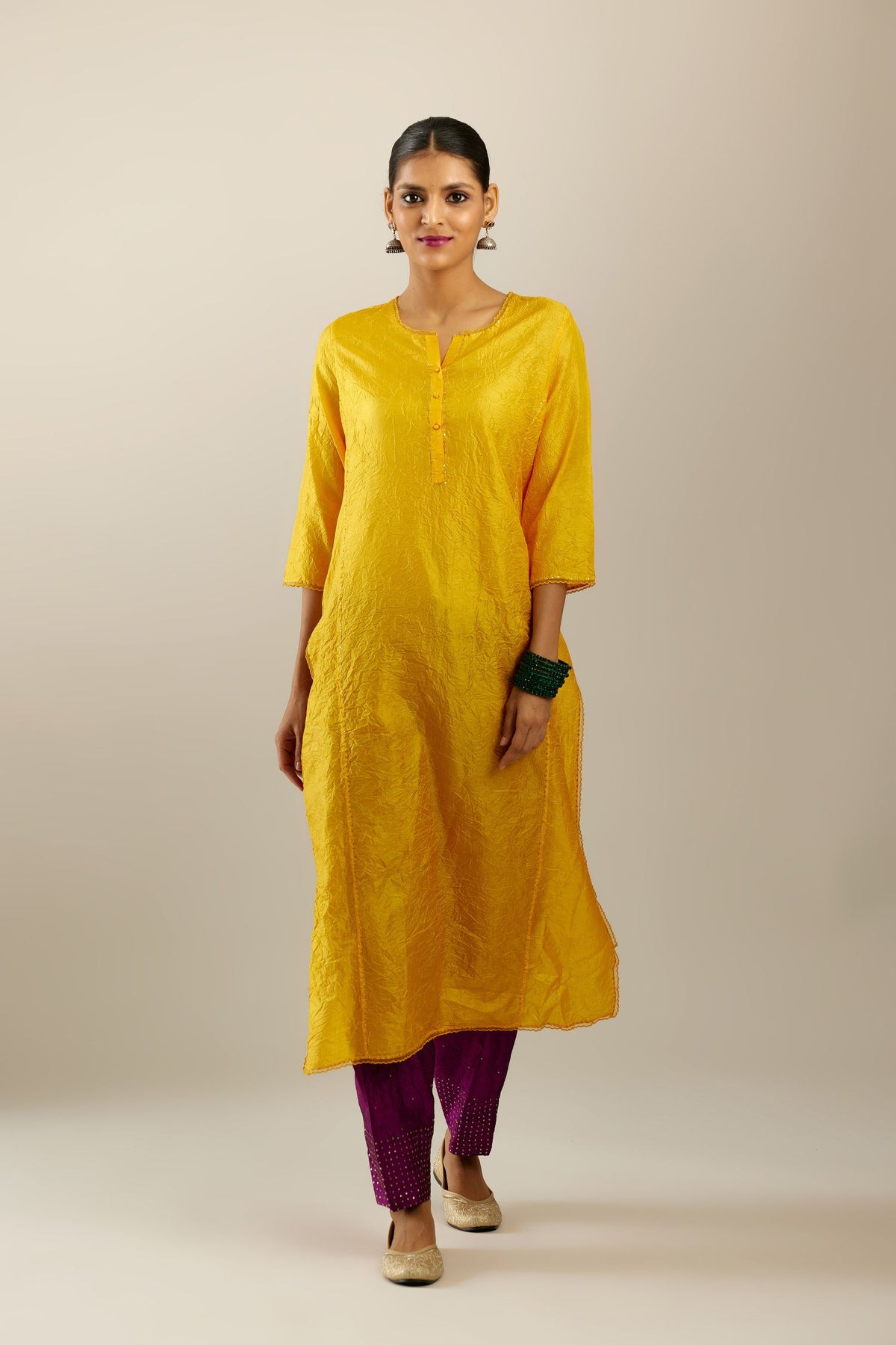 Silk hand crushed kurta set with concealed button placket neckline, highlighted with sequins and scalloped organza at edges.