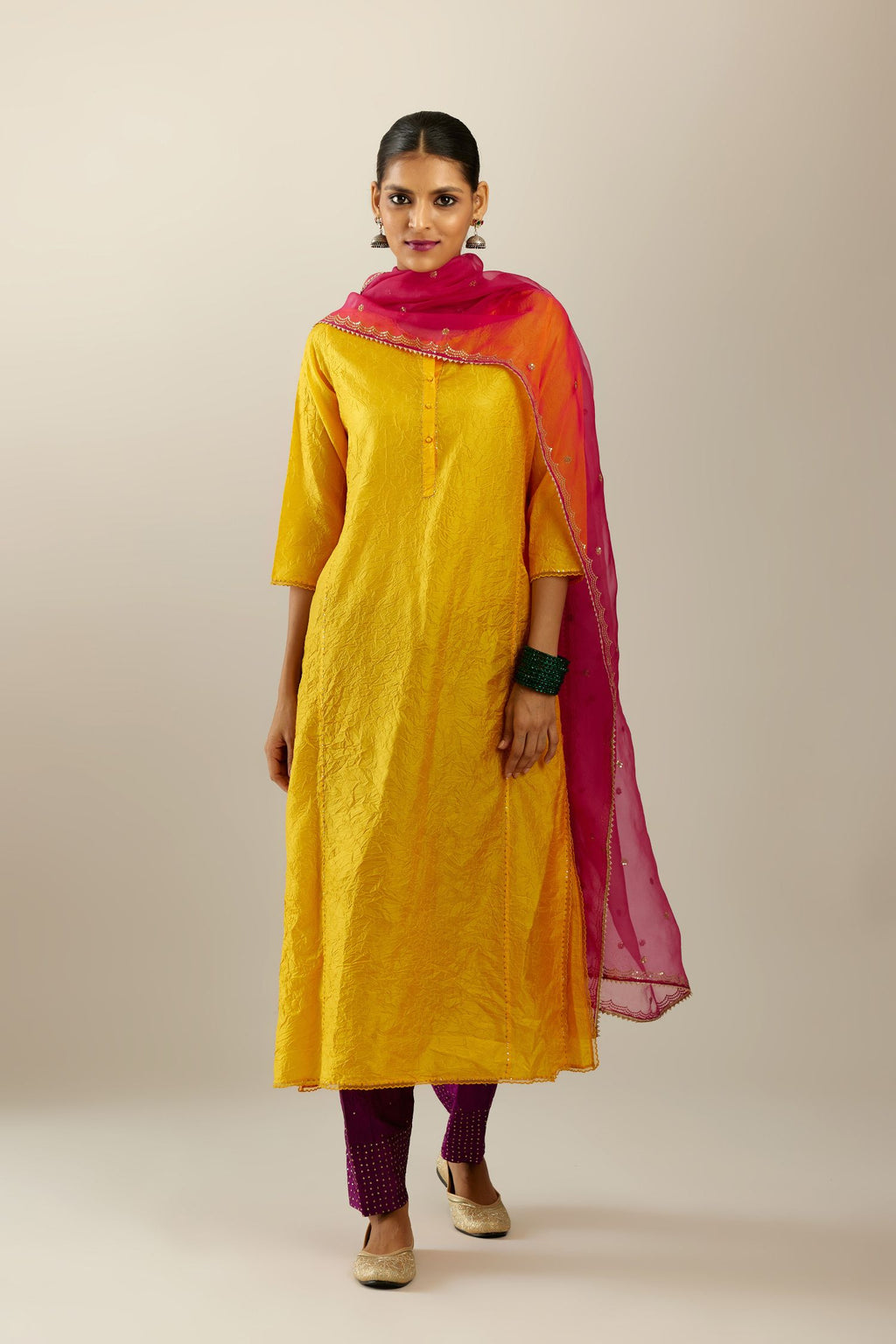Silk hand crushed kurta set with concealed button placket neckline, highlighted with sequins and scalloped organza at edges.