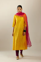 Silk hand crushed kurta set with concealed button placket neckline, highlighted with sequins and scalloped organza at edges.