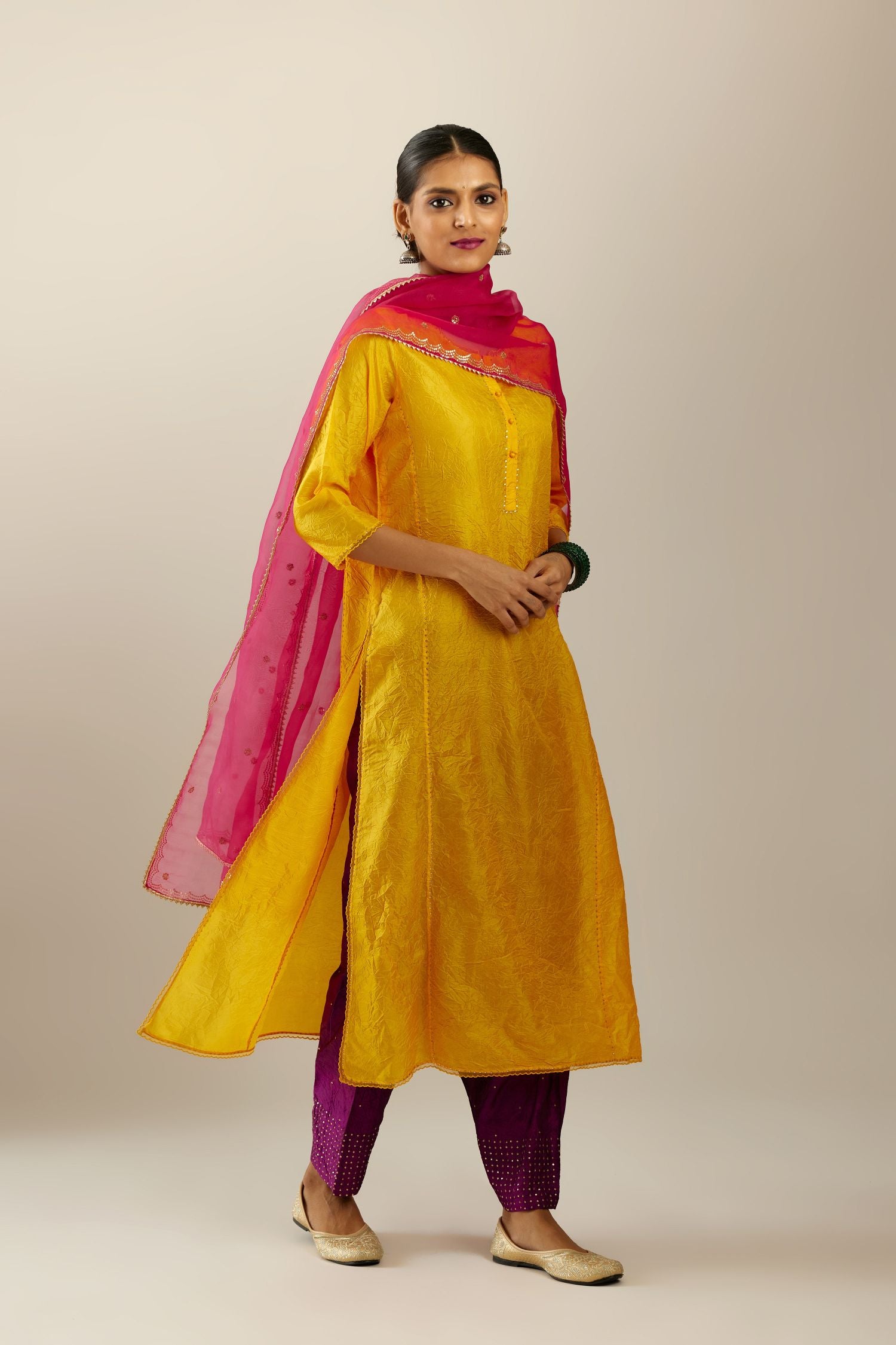 Silk hand crushed kurta set with concealed button placket neckline, highlighted with sequins and scalloped organza at edges.