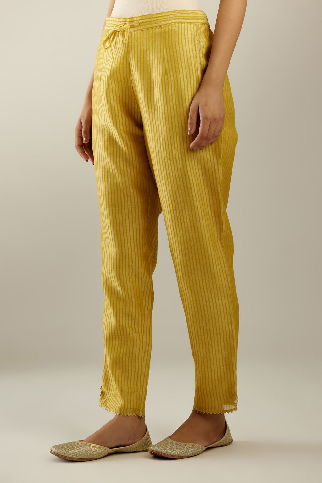 Yellow striped hand block printed silk chanderi pants, highlighted with gota and zari embroidery at hem.