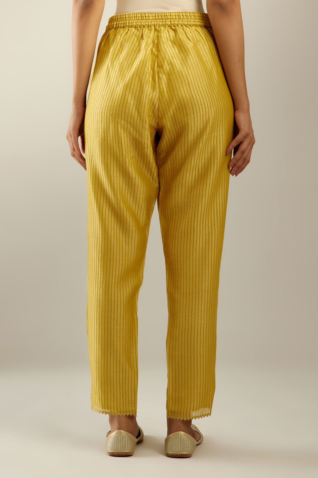Yellow striped hand block printed silk chanderi pants, highlighted with gota and zari embroidery at hem.