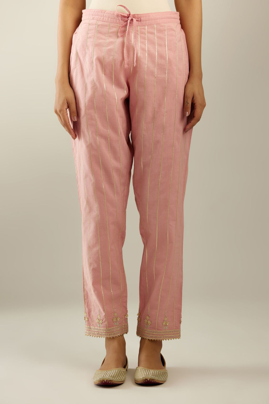 Pink cotton straight pants with all-over gold gota lines and zari embroidery at hem.