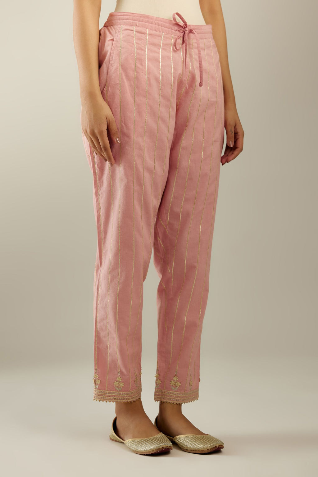 Pink cotton straight pants with all-over gold gota lines and zari embroidery at hem.
