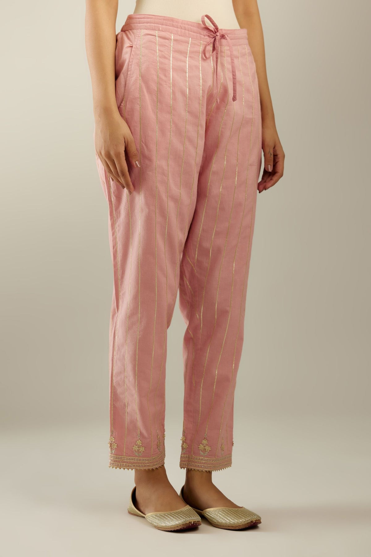Pink cotton straight pants with all-over gold gota lines and zari embroidery at hem.