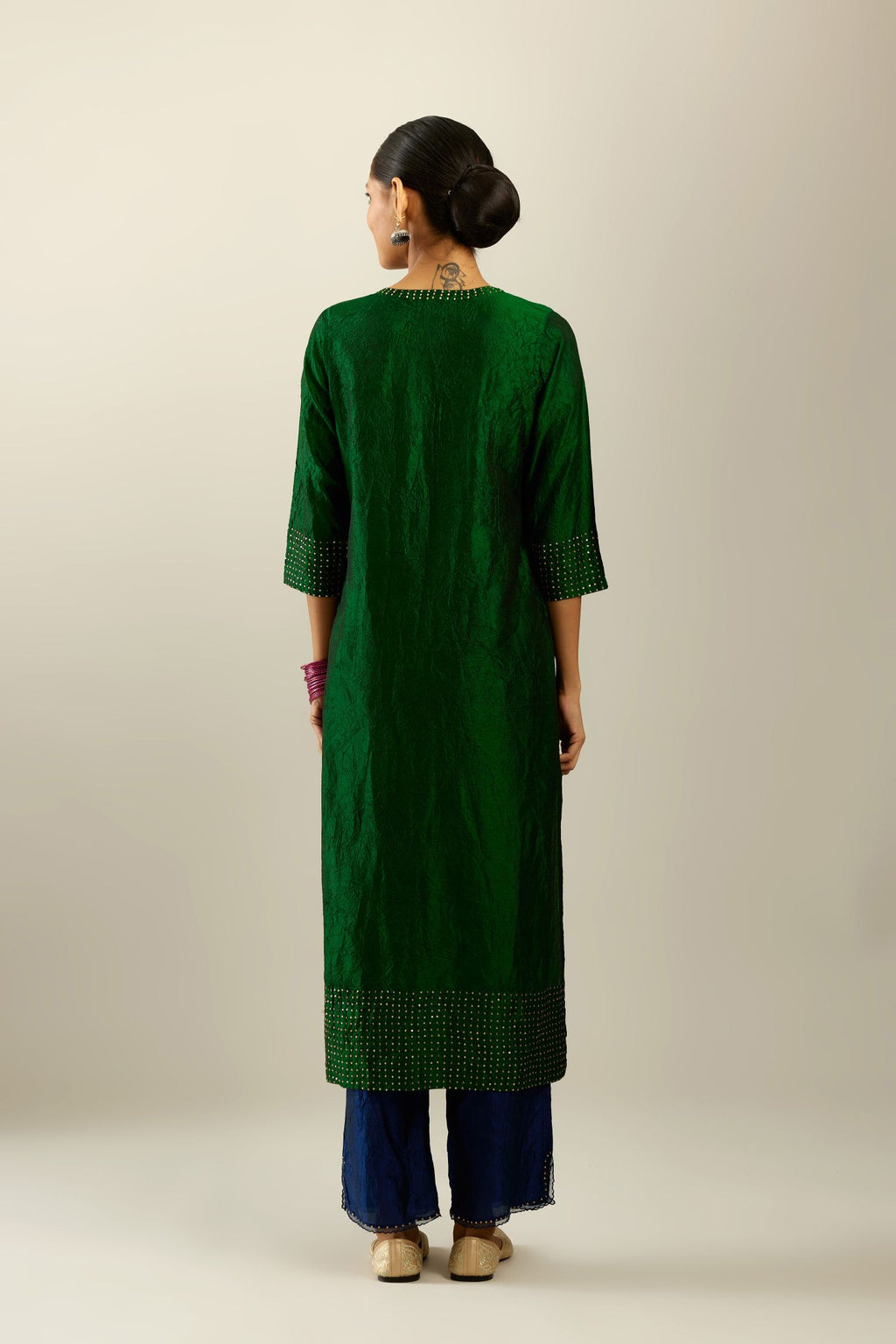 Dark green silk hand crushed kurta set with concealed button placket neckline, highlighted with gold sequins.