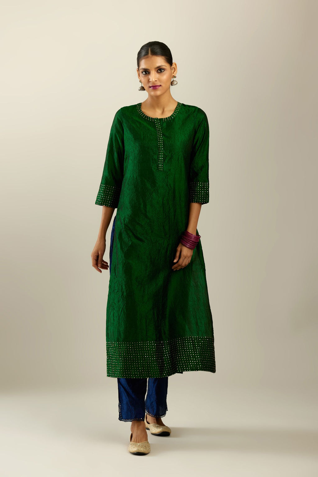 Dark green silk hand crushed kurta set with concealed button placket neckline, highlighted with gold sequins.