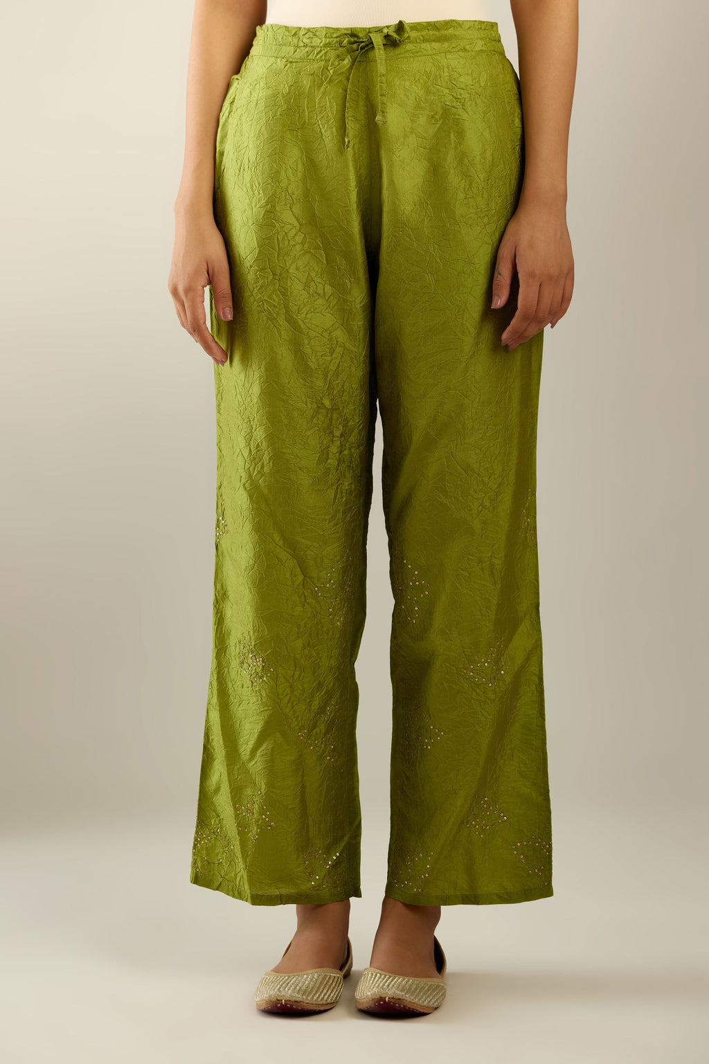 Apple green crushed silk pants with side pockets and assorted sequined butterflies till mid-calf length.