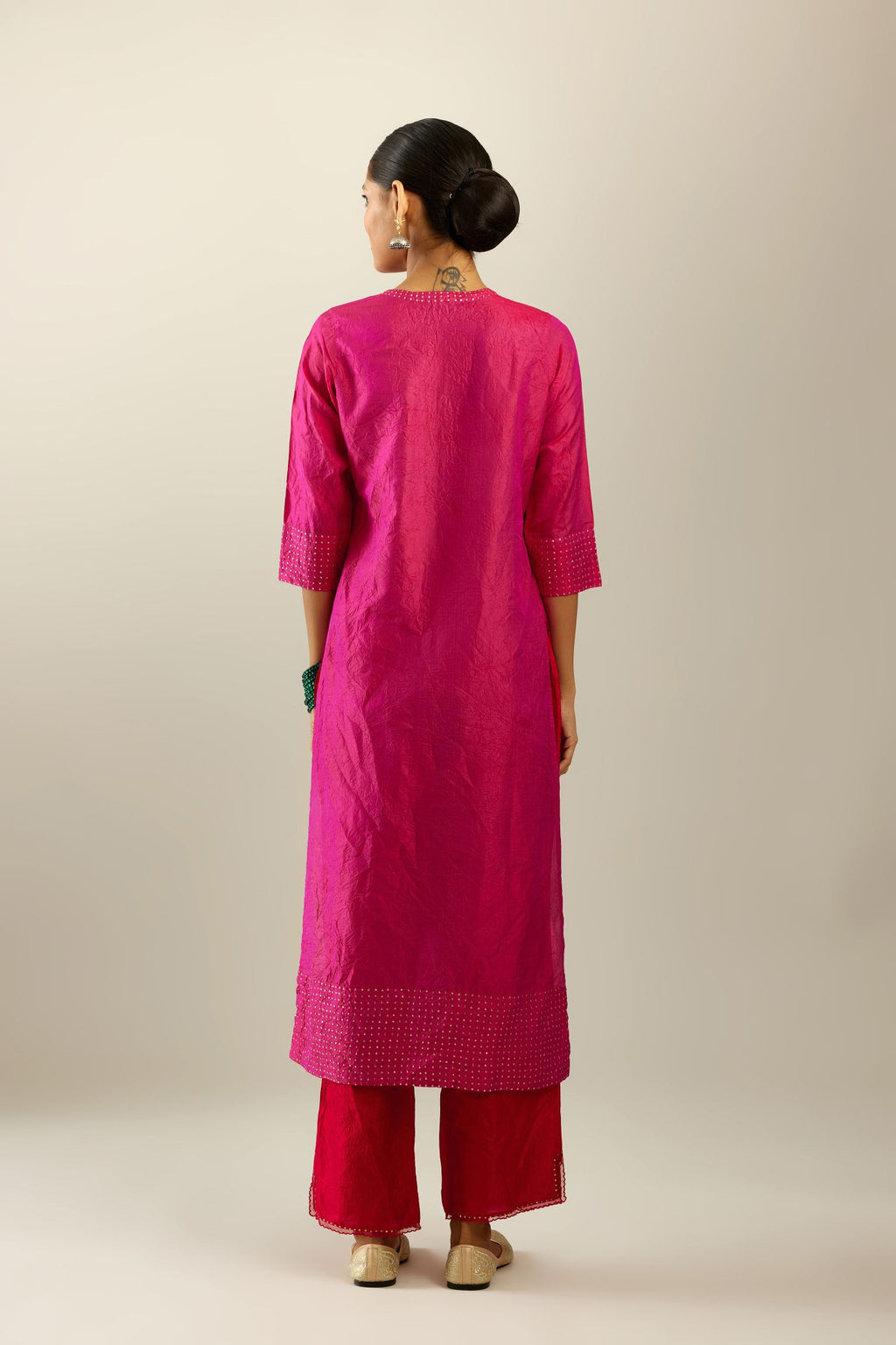 Raspberry silk hand crushed kurta set with concealed button placket neckline, highlighted with gold sequins.