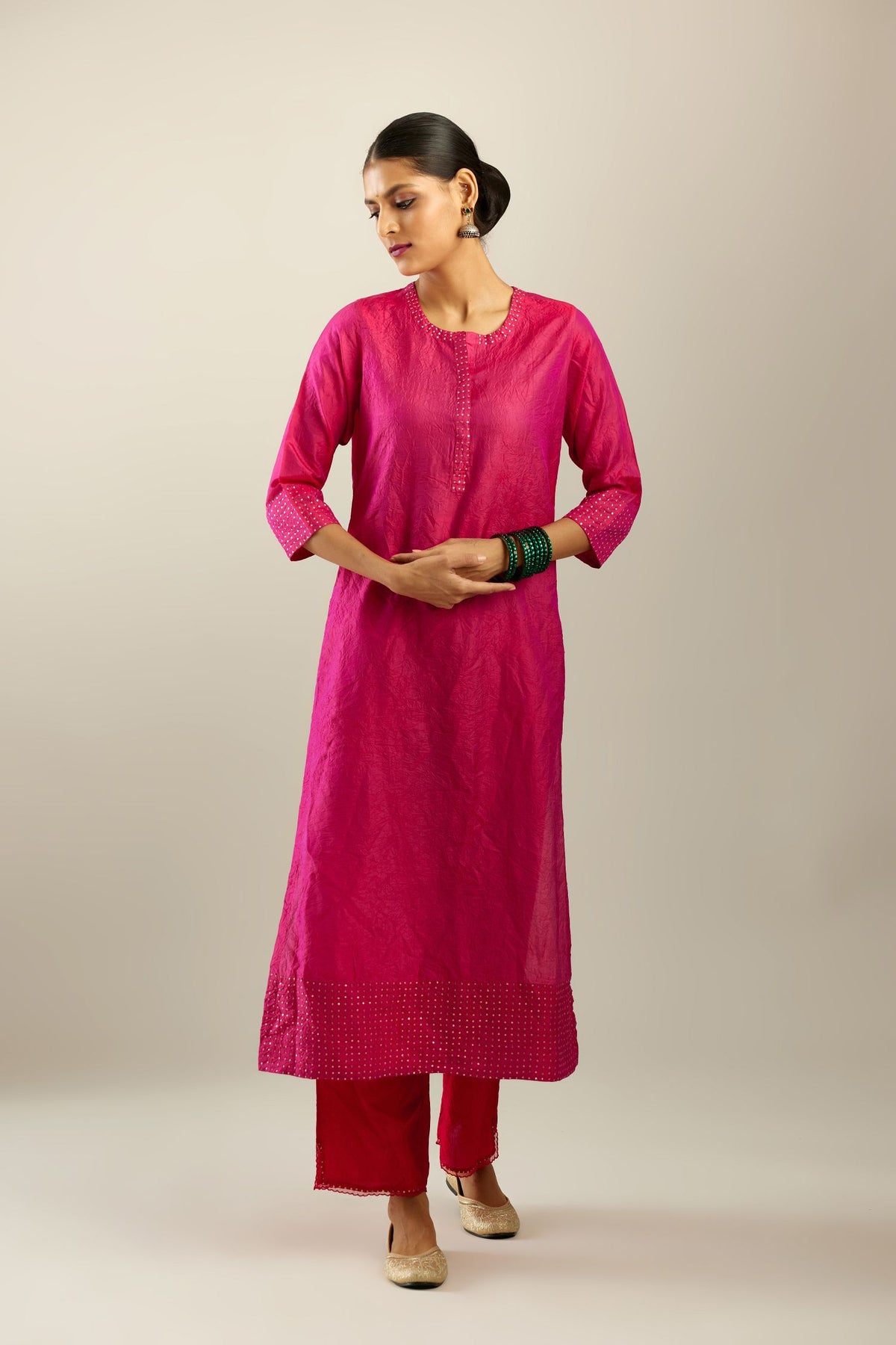 Raspberry silk hand crushed kurta set with concealed button placket neckline, highlighted with gold sequins.