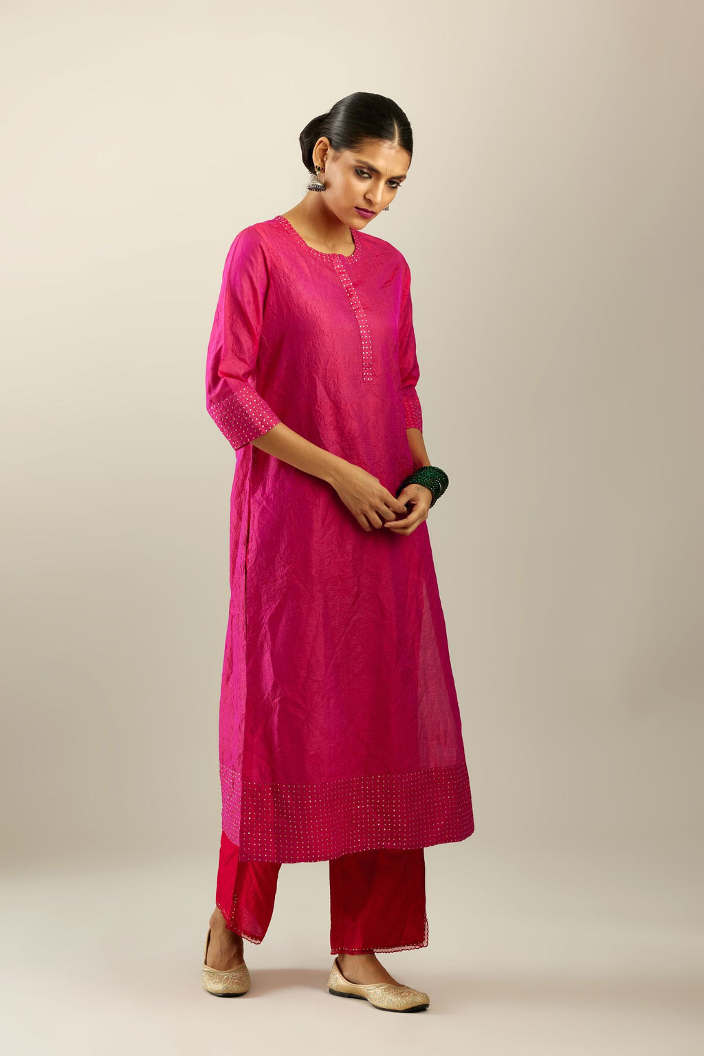 Raspberry silk hand crushed kurta set with concealed button placket neckline, highlighted with gold sequins.