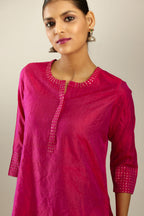 Raspberry silk hand crushed kurta set with concealed button placket neckline, highlighted with gold sequins.