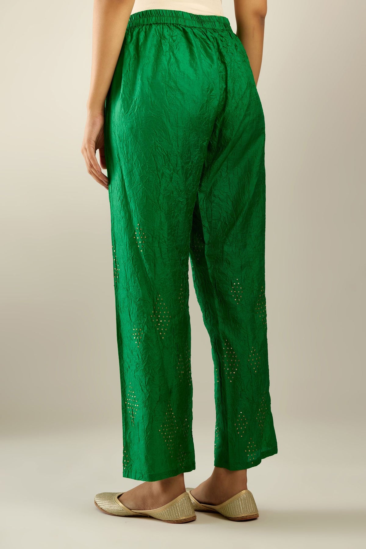 Grass green hand crushed pure silk straight pants with assorted diamond shape golden sequins work till knee length and side pockets.