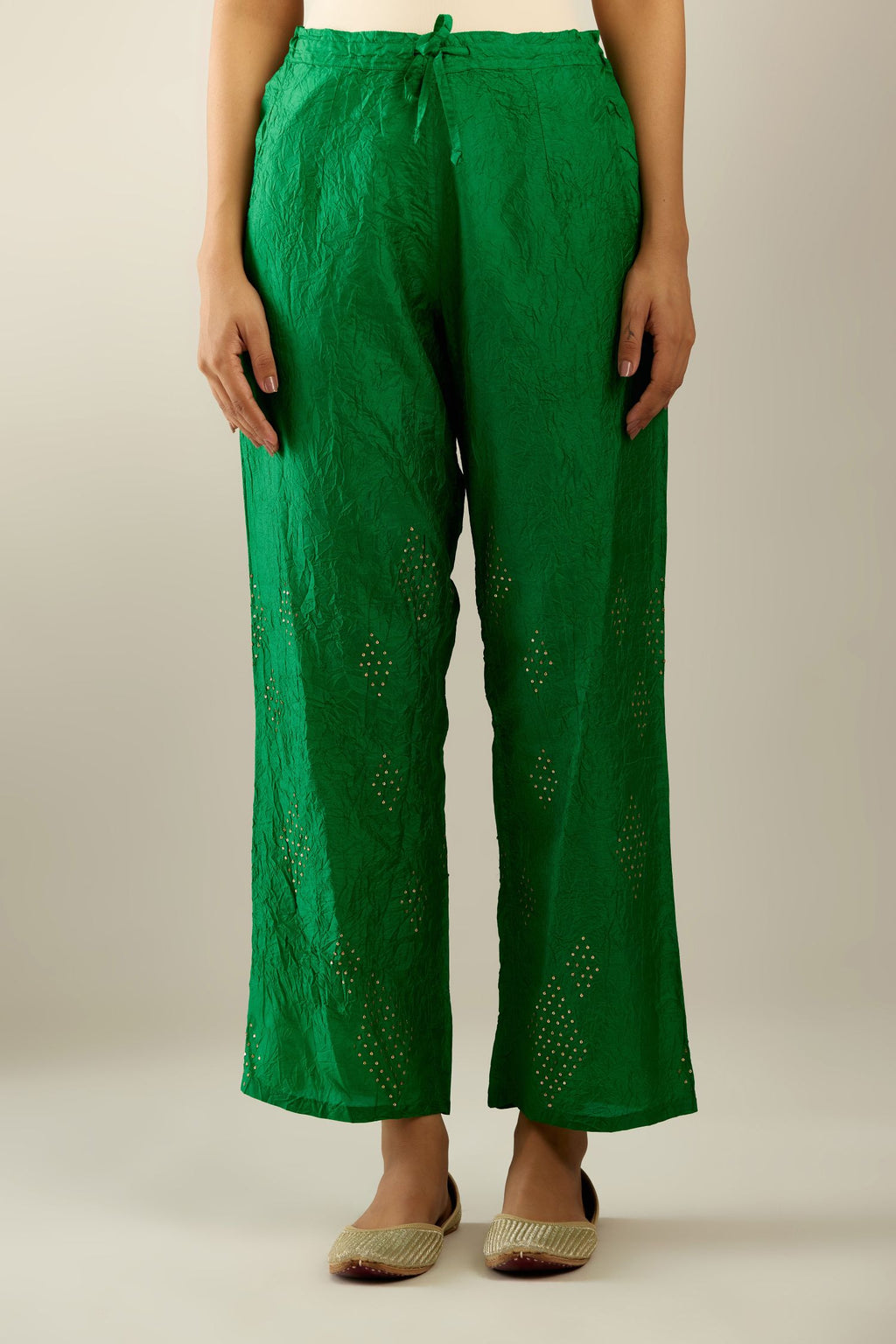 Grass green hand crushed pure silk straight pants with assorted diamond shape golden sequins work till knee length and side pockets.