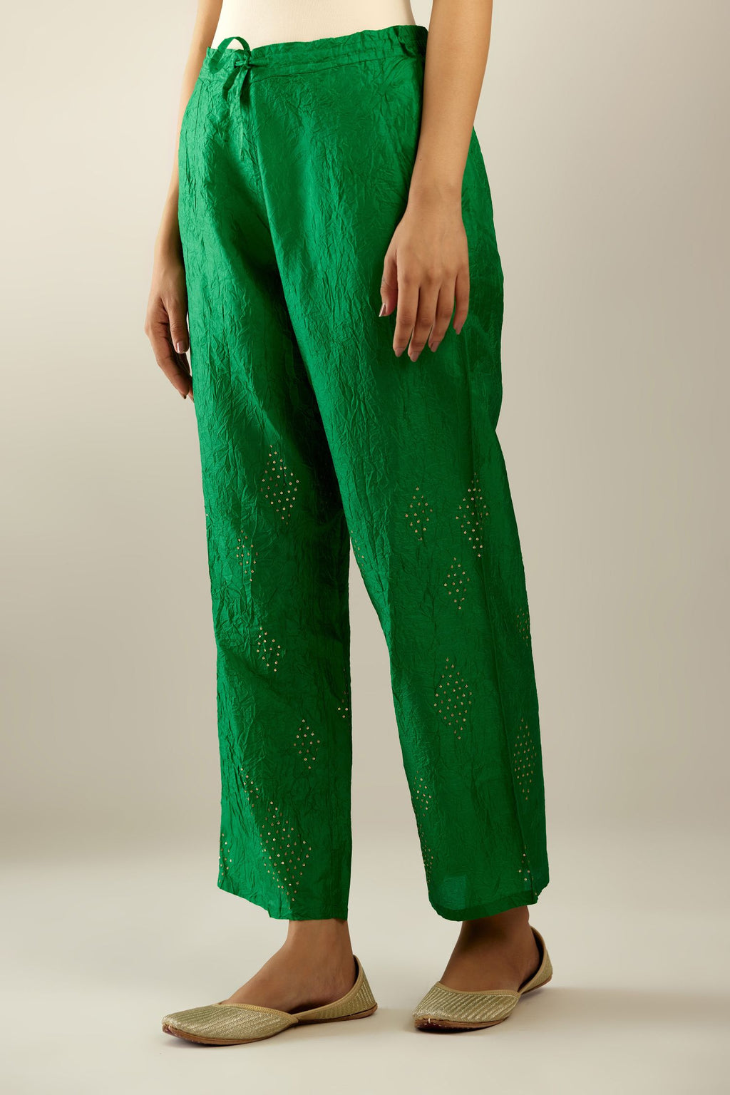 Grass green hand crushed pure silk straight pants with assorted diamond shape golden sequins work till knee length and side pockets.