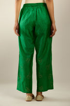 Grass green crushed silk pants with side pockets and assorted sequined butterflies till mid-calf length.
