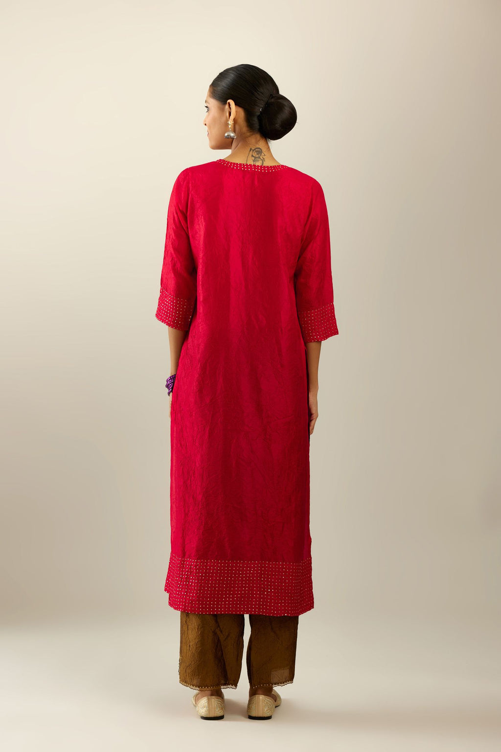 Red silk hand crushed kurta set with concealed button placket neckline, highlighted with gold sequins.