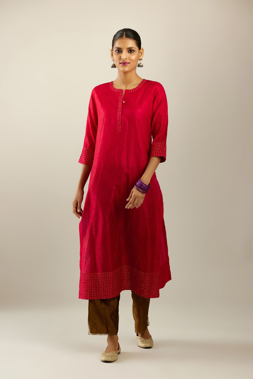 Red silk hand crushed kurta set with concealed button placket neckline, highlighted with gold sequins.