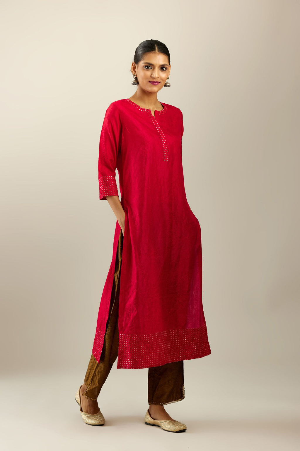 Red silk hand crushed kurta set with concealed button placket neckline, highlighted with gold sequins.