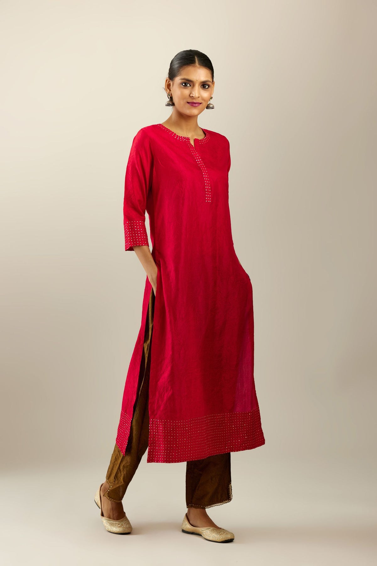 Red silk hand crushed kurta set with concealed button placket neckline, highlighted with gold sequins.