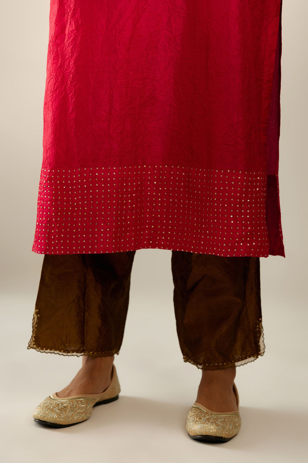 Red silk hand crushed kurta set with concealed button placket neckline, highlighted with gold sequins.