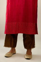 Red silk hand crushed kurta set with concealed button placket neckline, highlighted with gold sequins.