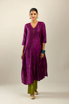 Sangria silk hand crushed A-line kurta set with asymmetric hem, highlighted with all-over gold sequins diamonds.