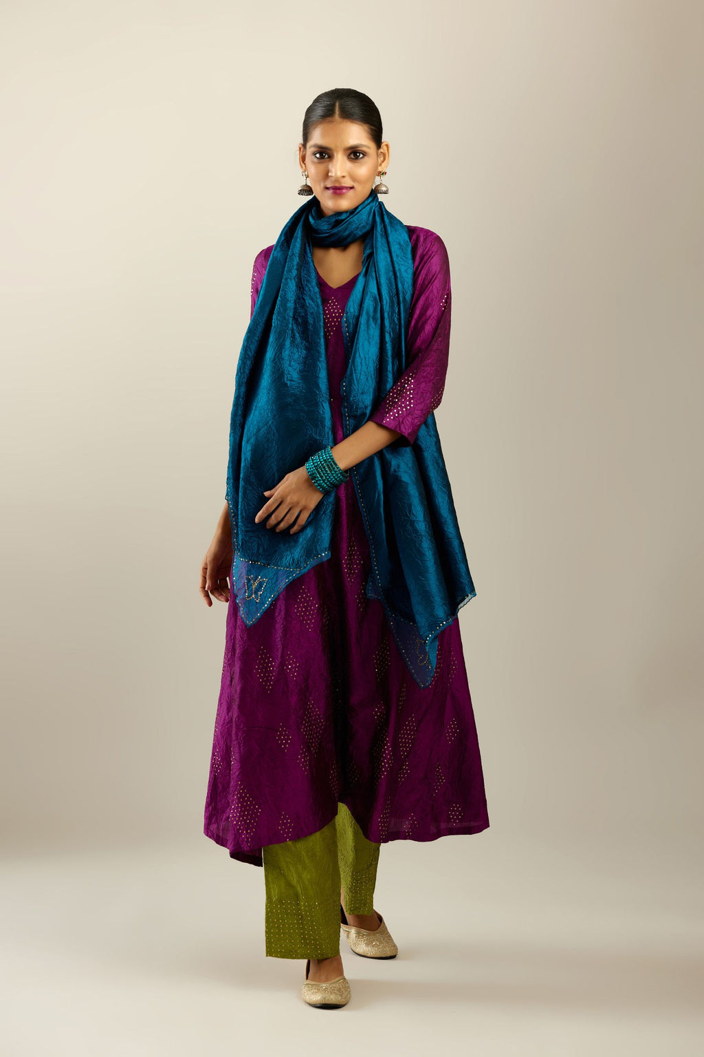 Sangria silk hand crushed A-line kurta set with asymmetric hem, highlighted with all-over gold sequins diamonds.
