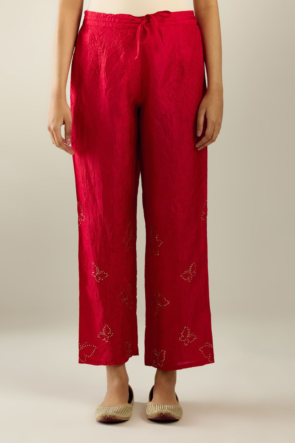 Red silk pants with side pockets and assorted sequined butterflies till mid-calf length.