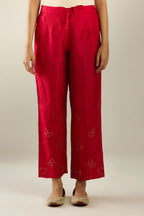 Red silk pants with side pockets and assorted sequined butterflies till mid-calf length.