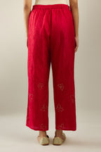 Red silk pants with side pockets and assorted sequined butterflies till mid-calf length.