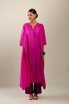 Fiji fuchsia hand crushed silk kurta set with asymmetric hem, highlighted with gold sequins and embroidered scalloped organza at edges.