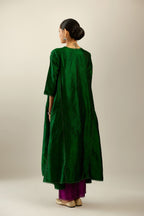 Dark green hand crushed silk kurta set with asymmetric hem, highlighted with gold sequins and embroidered scalloped organza at edges.