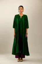 Dark green hand crushed silk kurta set with asymmetric hem, highlighted with gold sequins and embroidered scalloped organza at edges.