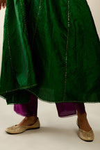 Dark green hand crushed silk kurta set with asymmetric hem, highlighted with gold sequins and embroidered scalloped organza at edges.