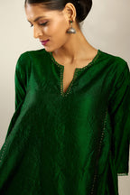 Dark green hand crushed silk kurta set with asymmetric hem, highlighted with gold sequins and embroidered scalloped organza at edges.