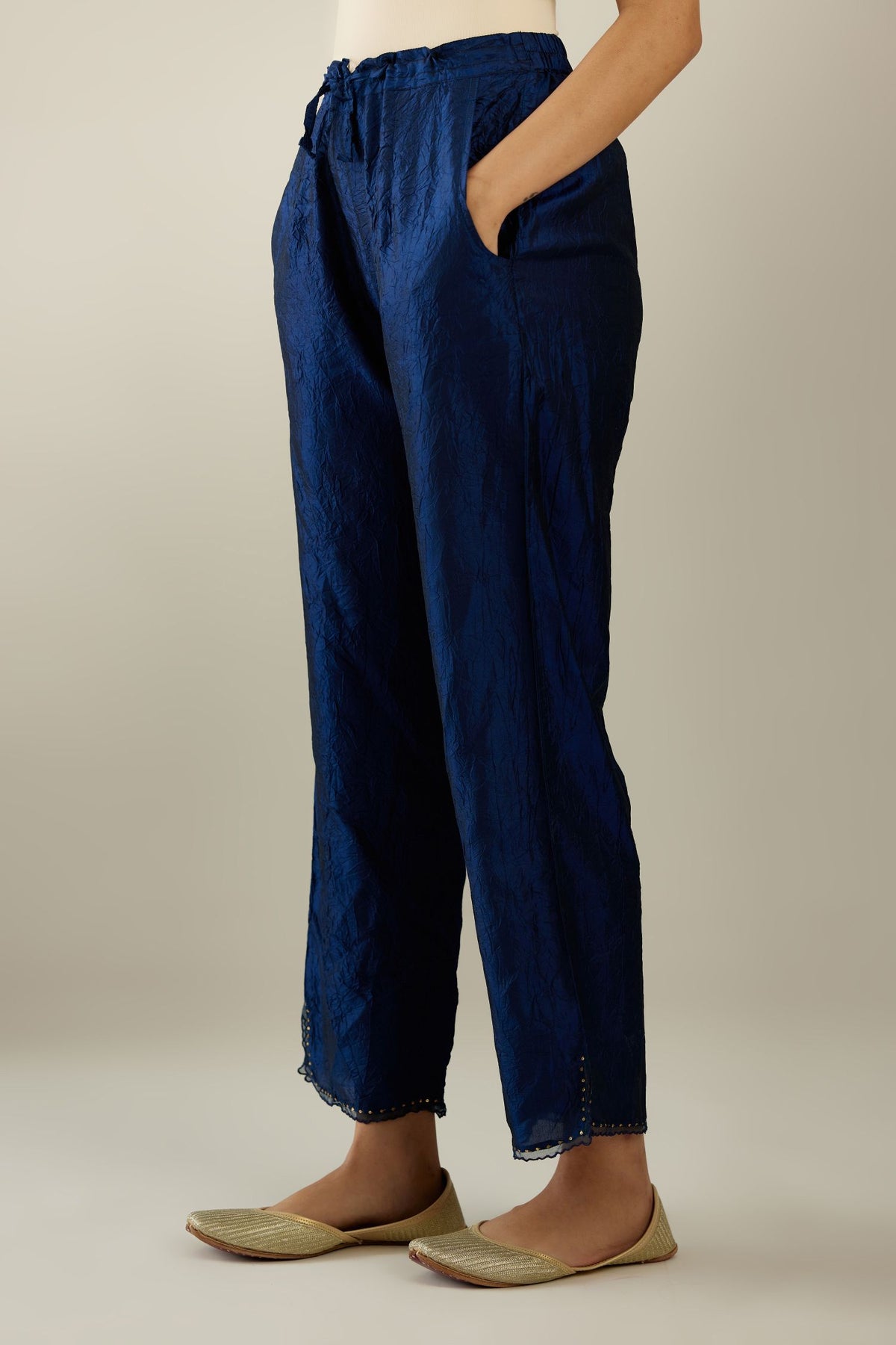 Navy blue hand crushed silk straight pants with scalloped and embroidered organza at edges and detailed with a single line of sequins at hem