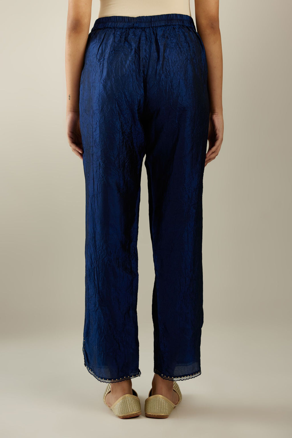 Navy blue hand crushed silk straight pants with scalloped and embroidered organza at edges and detailed with a single line of sequins at hem