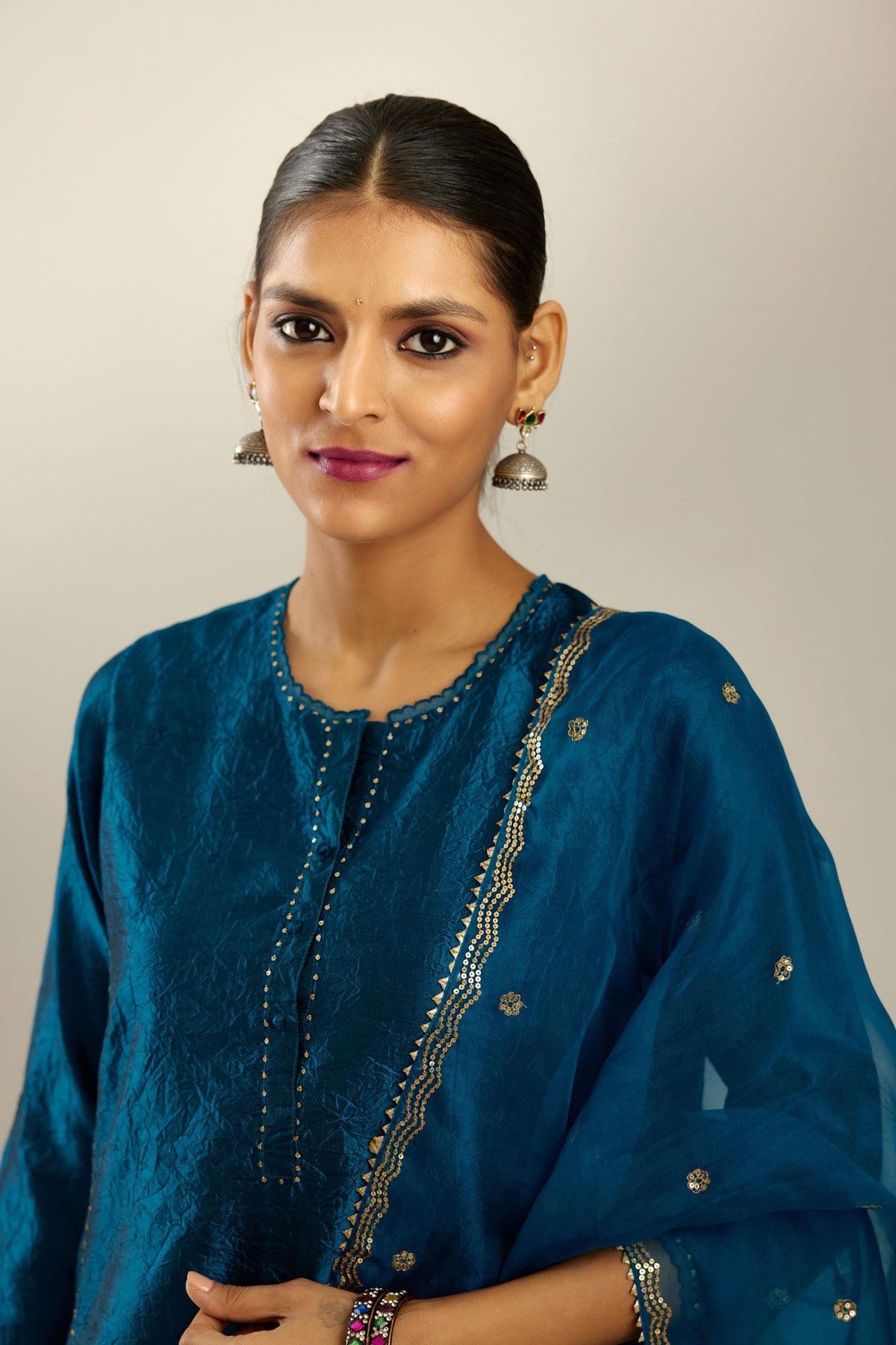 Silk hand crushed kurta set with concealed button placket neckline, highlighted with sequins and scalloped organza at edges.