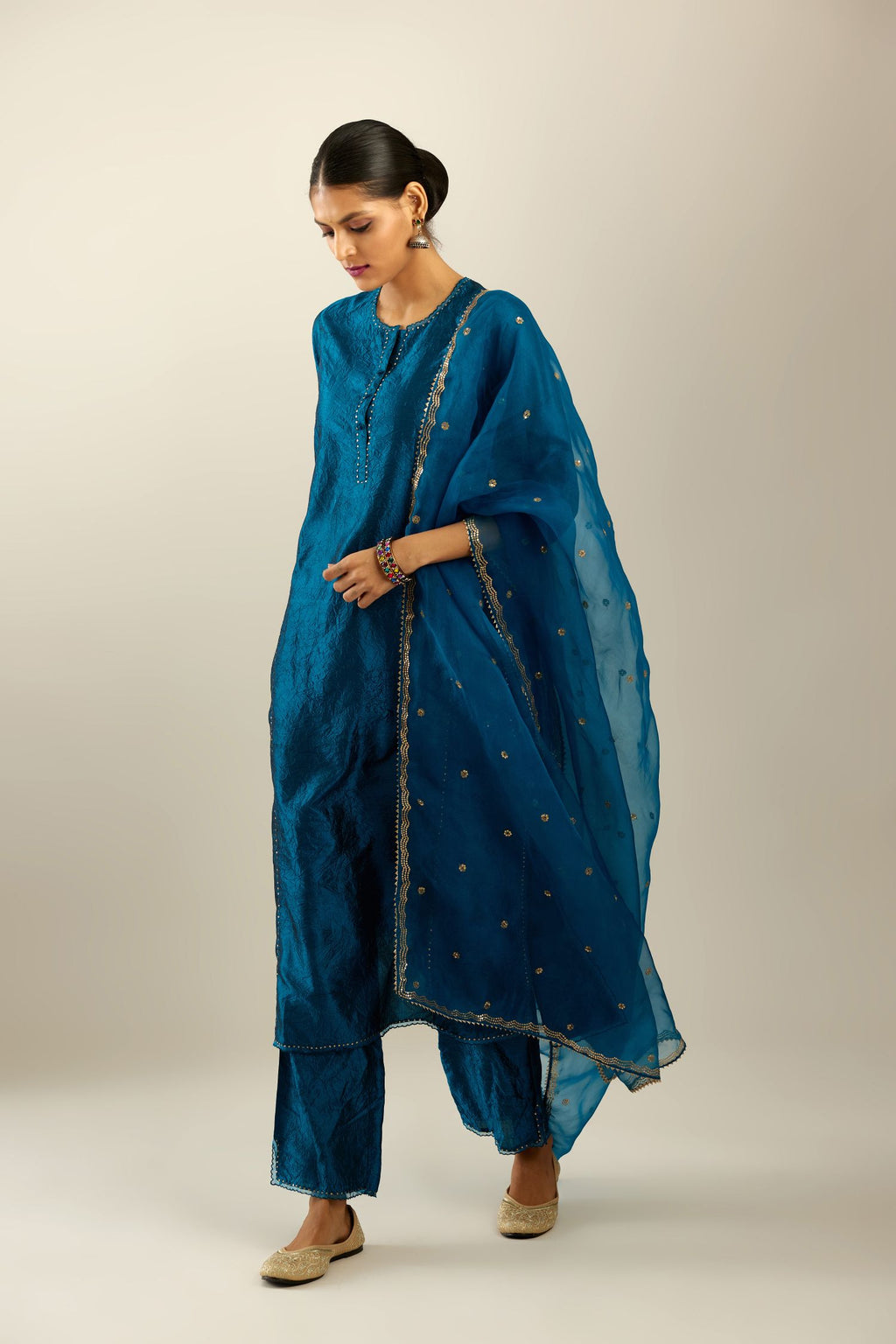 Silk hand crushed kurta set with concealed button placket neckline, highlighted with sequins and scalloped organza at edges.