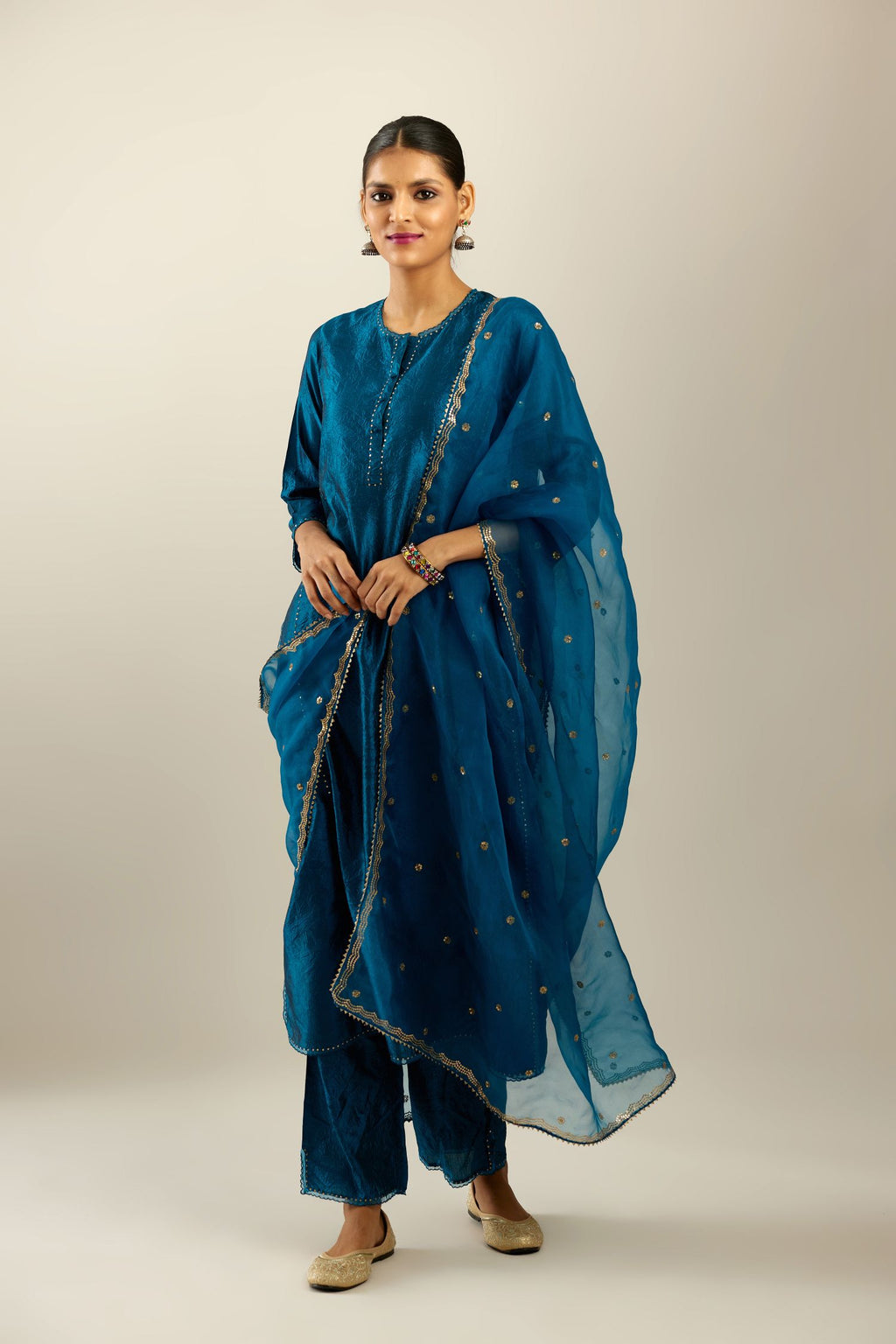 Dark teal silk organza dupatta with golden sequins butis all over with a sequined scalloped edge.