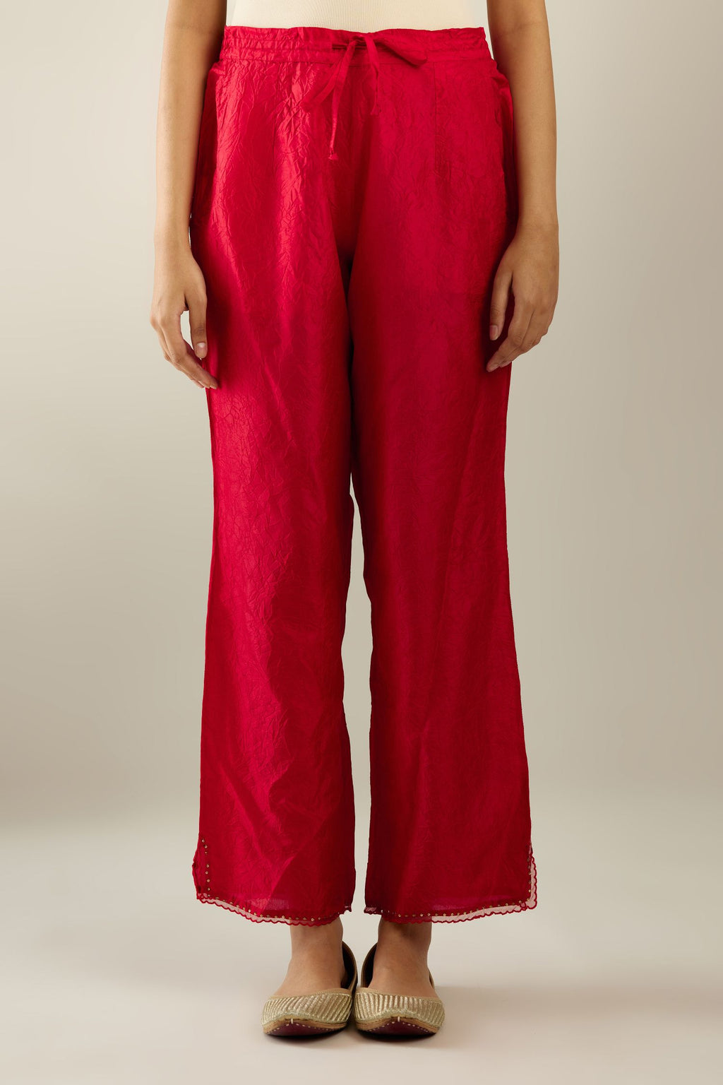 Red hand crushed silk straight pants with scalloped and embroidered organza at edges and detailed with a single line of sequins at hem