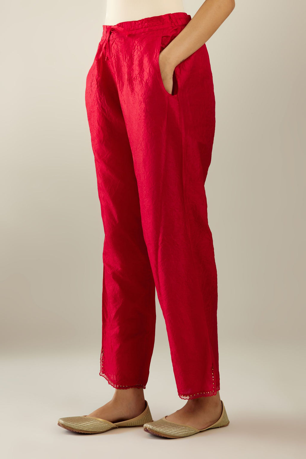 Red hand crushed silk straight pants with scalloped and embroidered organza at edges and detailed with a single line of sequins at hem