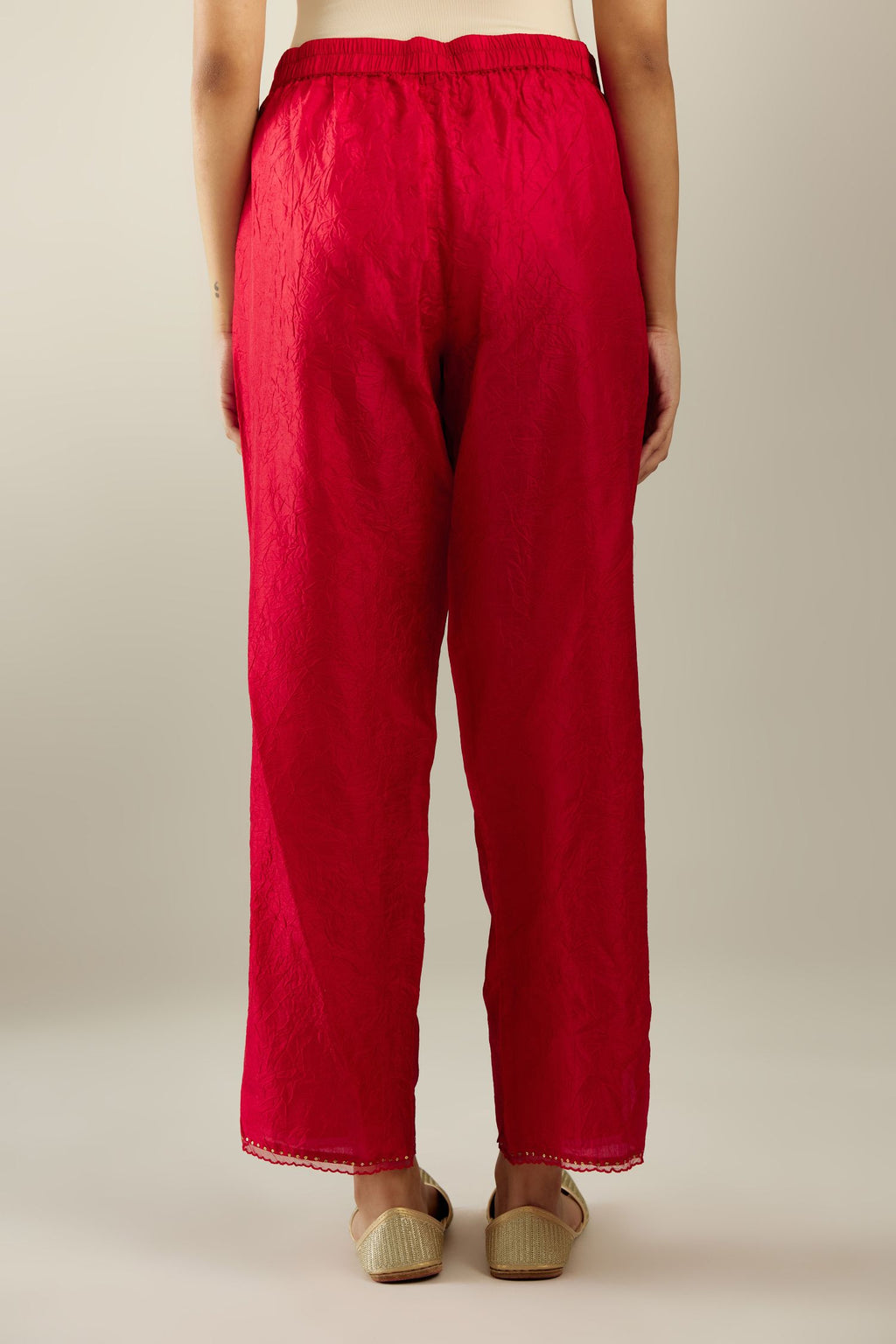 Red hand crushed silk straight pants with scalloped and embroidered organza at edges and detailed with a single line of sequins at hem
