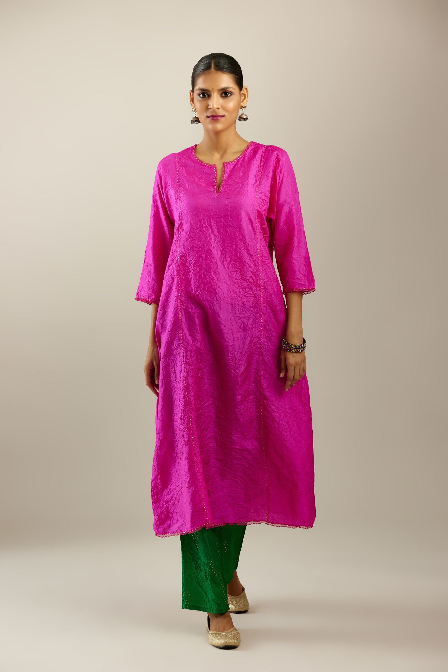 Silk hand crushed A-line kurta set, highlighted with gold sequins and embroidered scalloped edges.
