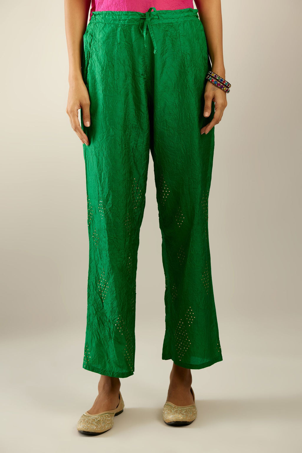 Grass green hand crushed pure silk straight pants with assorted diamond shape golden sequins work till knee length and side pockets.