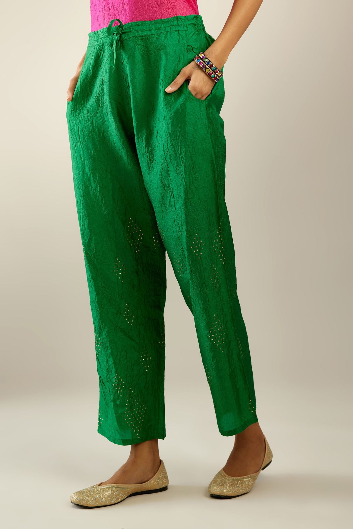 Grass green hand crushed pure silk straight pants with assorted diamond shape golden sequins work till knee length and side pockets.