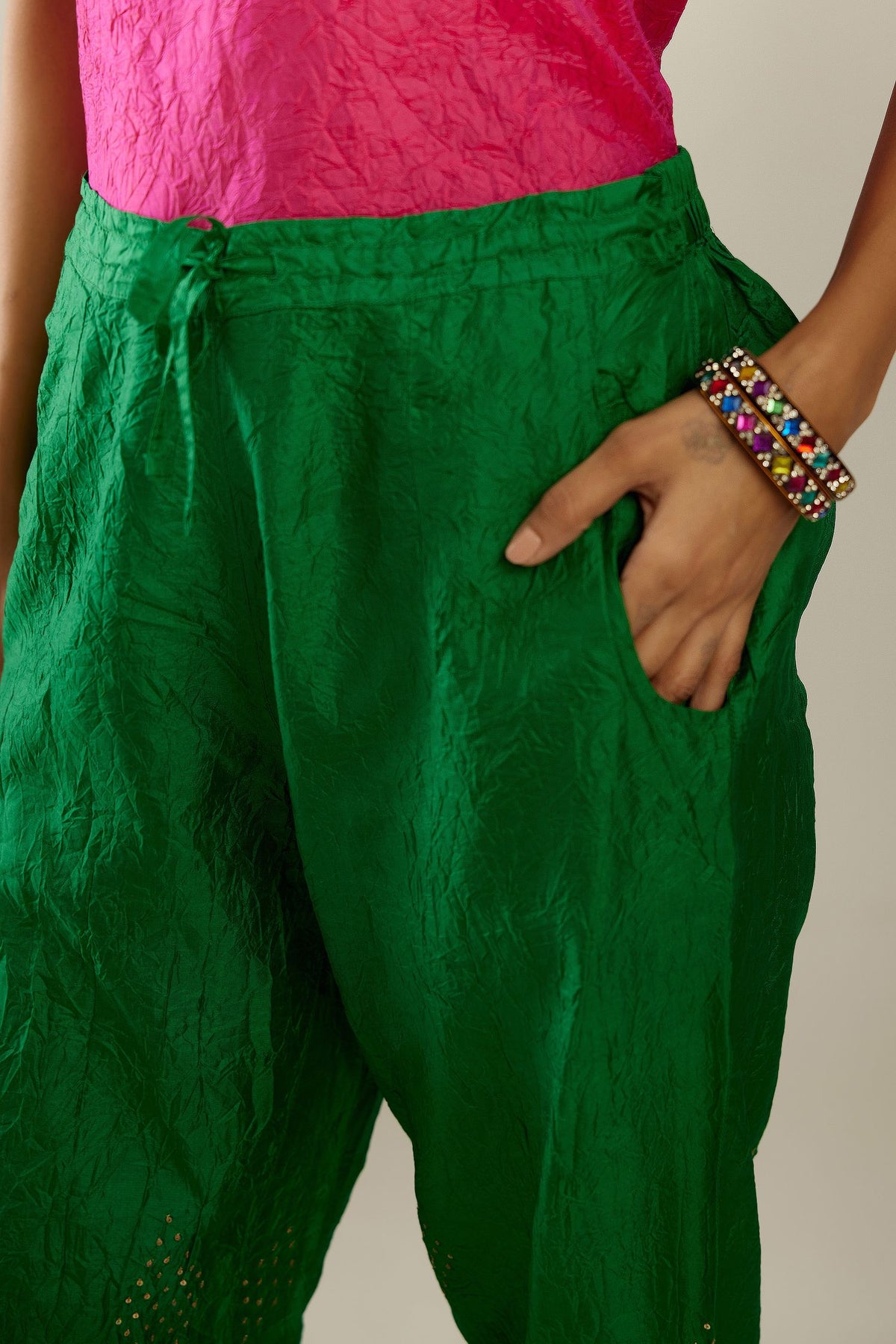 Grass green hand crushed pure silk straight pants with assorted diamond shape golden sequins work till knee length and side pockets.